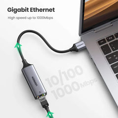 A Photo Of Ugreen CM209 - Aluminum USB 3.0 to Gigabit Ethernet Adapter - High-Speed Network Connectivity for Laptops and Chromebooks